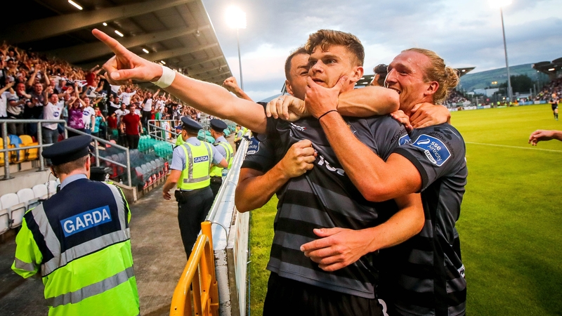 Sean Gannon celebrates scoring the first goal Brian Gartland and John Mountney