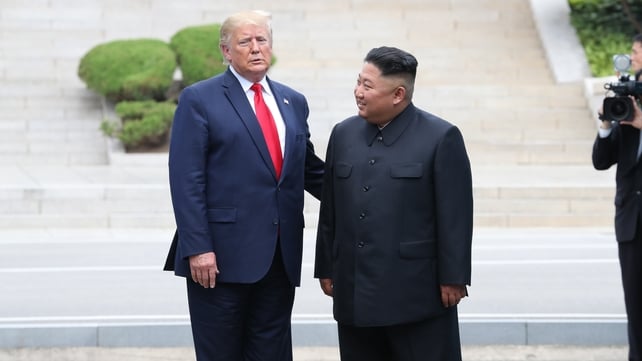 The two stand for photos for reporters at the border