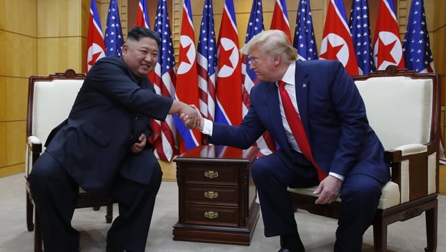 The pair shake hands during a sit down meeting