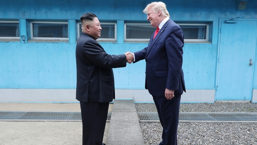 The two leaders shook hands over the concrete slabs dividing North and South