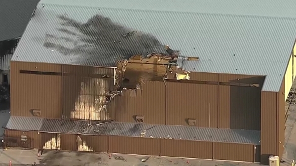 Investigators said the plane hit a private hangar at the airport
