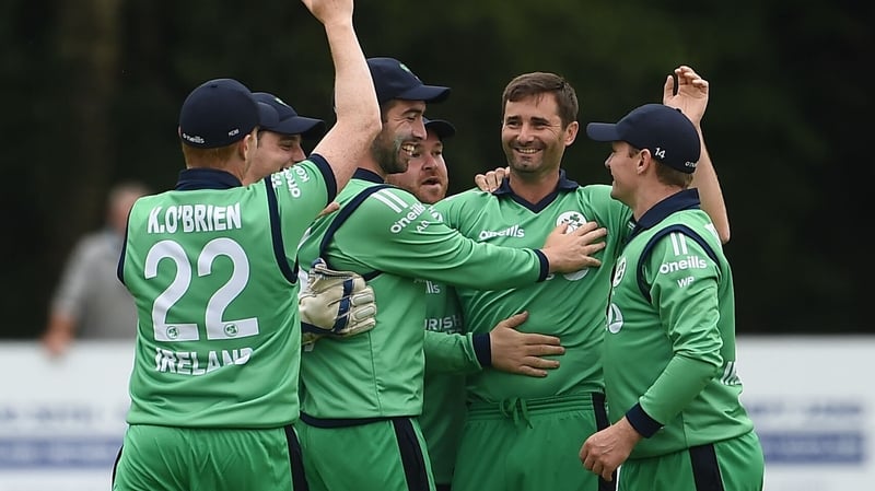 Tim Murtagh (C) is mobbed by team-mates after taking a wicket