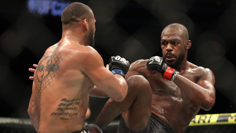 Jon Jones kicks Thiago Santos during the main event at UFC 239