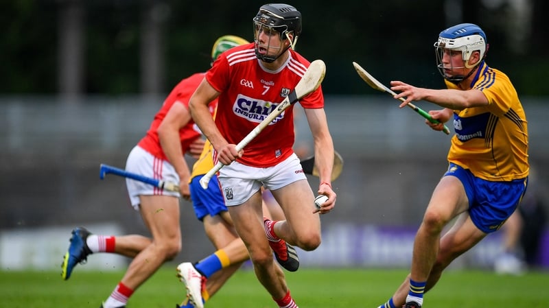 Cork's Robert Downey breaks clear of the challenge of Diarmuid Ryan