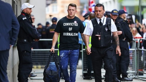 Tommy Robinson (L) arriving at court