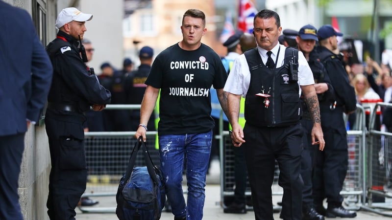 Tommy Robinson (L) arriving at court