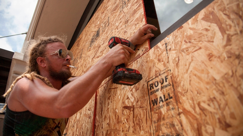 Matt Harrington boards up a Vans shoe store near the French Quarter in New Orleans as Tropical Storm Barry approaches