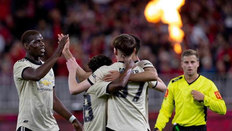 Manchester United's Paul Pogba (L) celebrates with James Garner