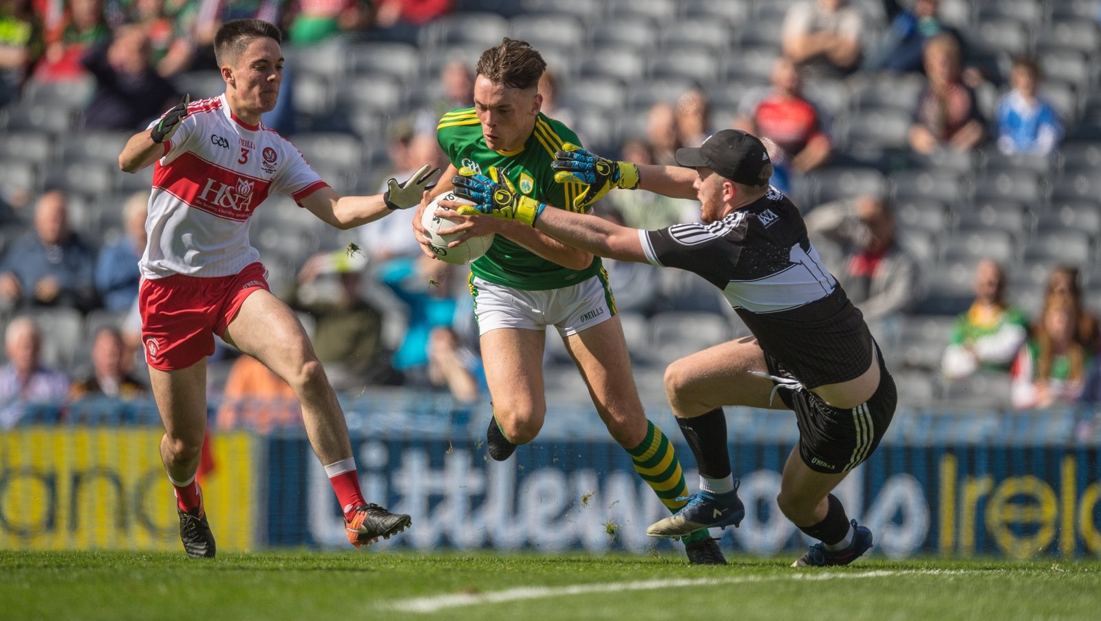 Clifford goes round Derry goalkeeper Oran Hartin and full-back Conor McCluskey