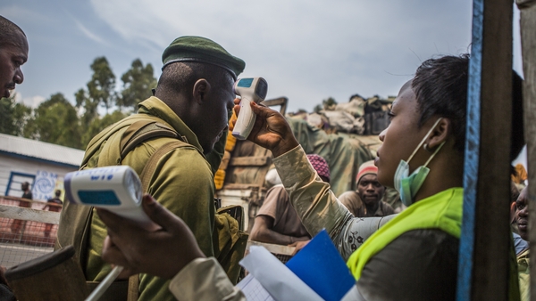 A healthworker screens people for Ebola symptoms in eastern Democratic Republic of Congo
