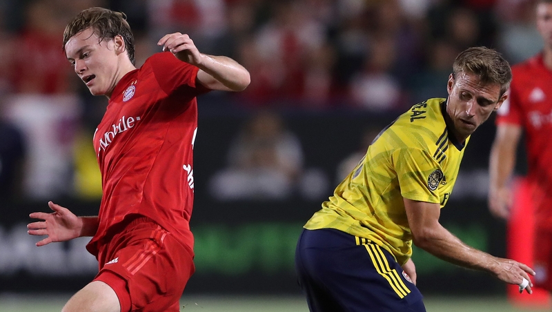 Ryan Johansson (L) battles for possession with Nacho Monreal