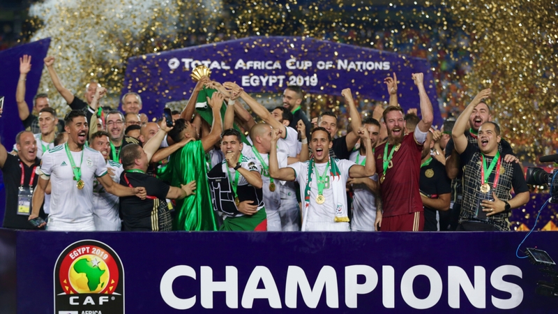 Algeria celebrate with the trophy following the victory