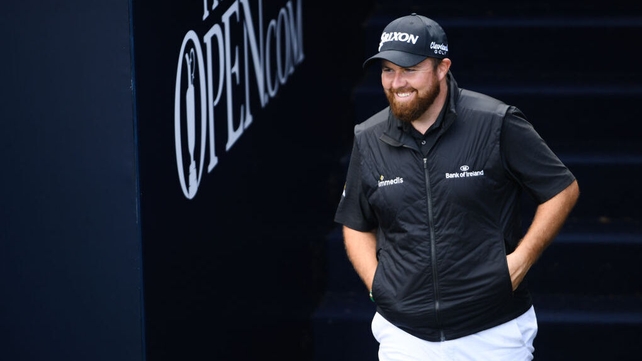 A composed Lowry walks onto the first tee on Saturday with a four-shot lead