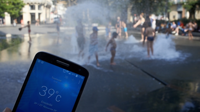 Children escape the 39C heat on the streets of Toulouse, France