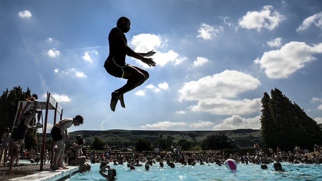 People of Yorkshire, England enjoy some rare time by the pool