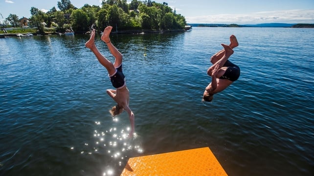 Two men enjoying the hot temperatures as far north as Norway