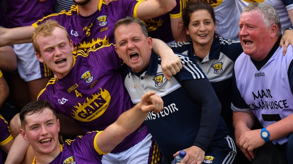 Fitzgerald celebrates with his players and backroom team
