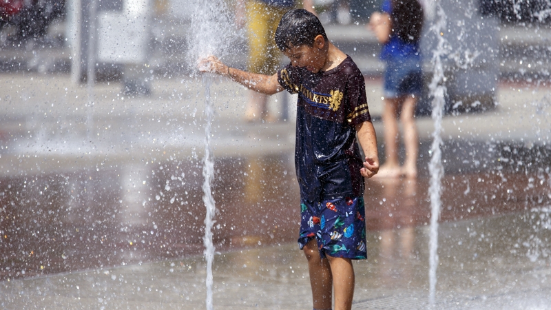 A young boy stays cool at Place des Nations in Geneva