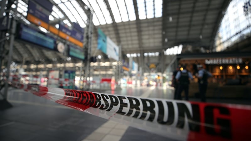 Police officers cordon off areas near the platforms at the main train station in Frankfurt