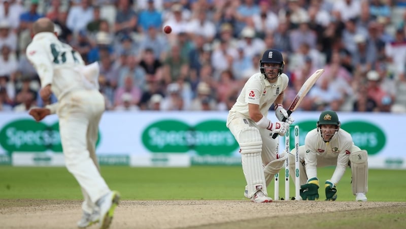 Australia's Nathan Lyon bowls the last ball of the day to Rory Burns
