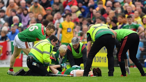 Jason Doherty is attended to by medical personnel at MacHale Park