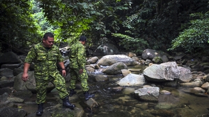The search is concentrated in the foothills of a mountain range and a forest reserve