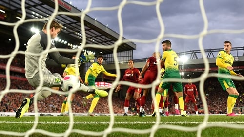 Virgil van Dijk of Liverpool scores