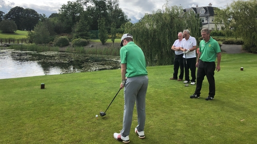 Patrick Morgan lines up a shot with assistance from his guide