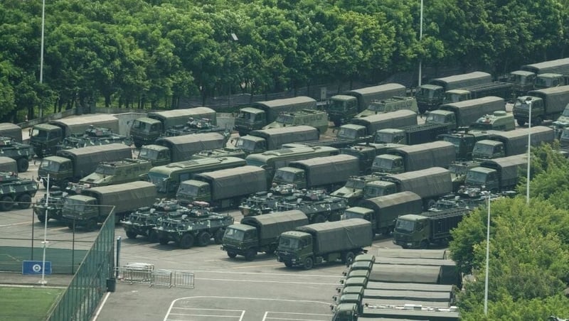Trucks and armoured personnel carriers are seen in Shenzhen, which borders Hong Kong on 15 August