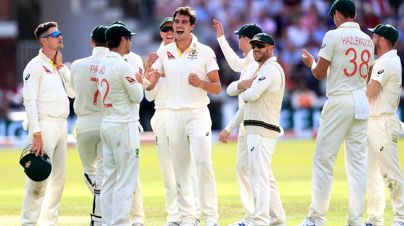 Australia's Pat Cummins (centre) celebrates taking the wicket of England's Chris Woakes
