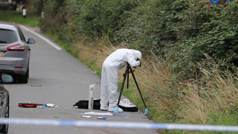 Forensic investigators gathering evidence on the road