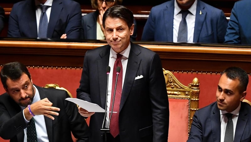 Giuseppe Conte (C) with ministers Matteo Salvini (L) and Luigi Di Maio during his resignation speech