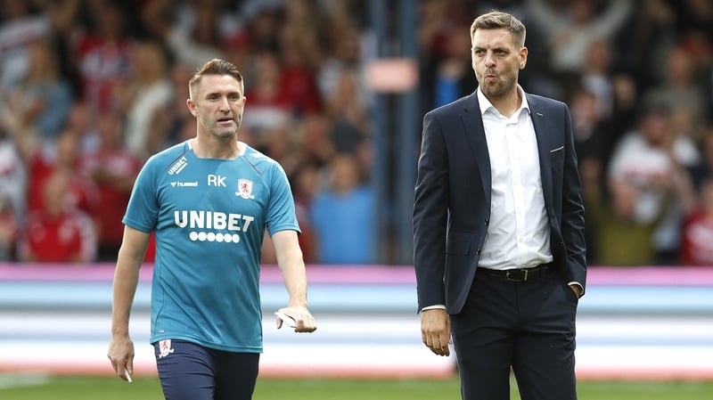 Robbie Keane (L) and Middlesbrough manager Jonathan Woodgate (right)