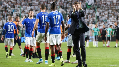 Steven Gerrard applauds the travelling support following the match in the Polish capital