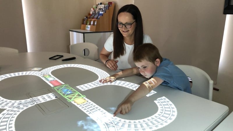 Claire Daly and her son Jack using the 'magic table' at Trim Library