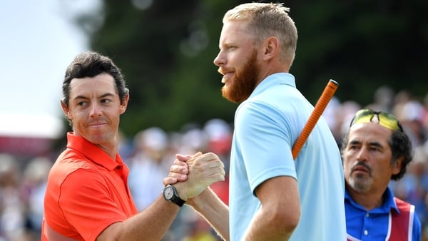 Rory McIlroy congratulates the champion Sebastian Soderberg following the play-off win