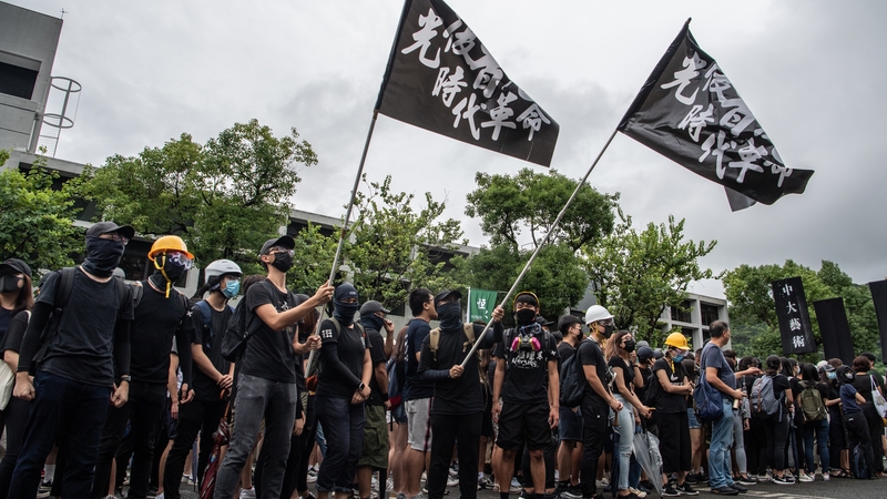 Students wave flags during anti-government protests at the Chinese University of Hong Kong
