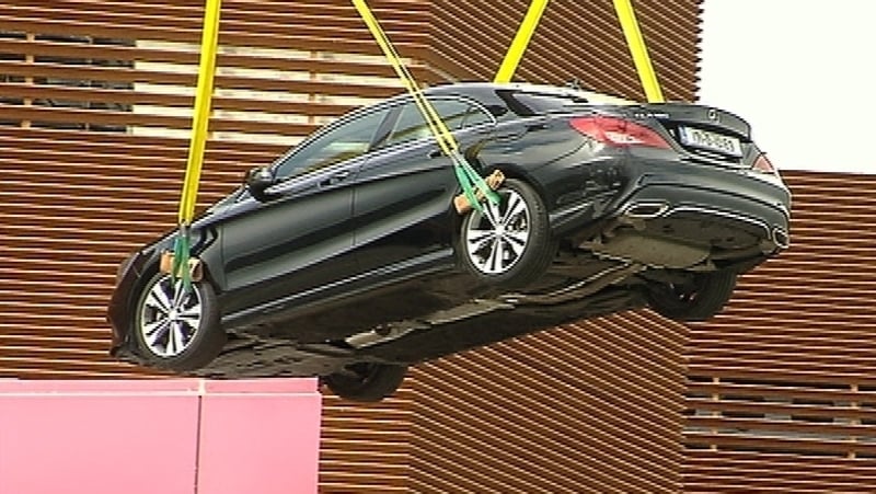 The cars are being removed from the car park by crane