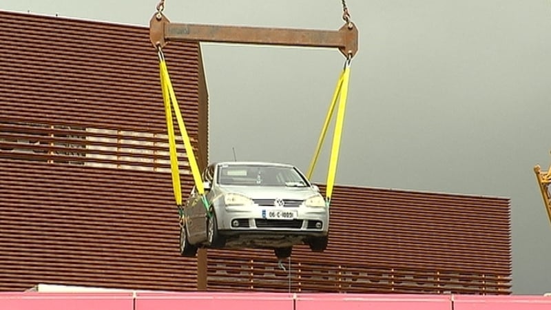 The last 28 cars undamaged cars are being towed to a nearby car park