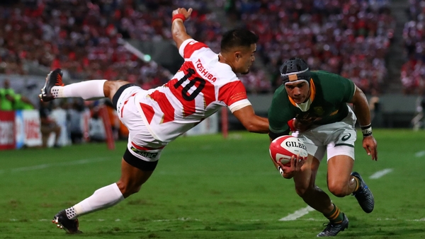 Makazole Mapimpi of South Africa barges past Yu Tamura to score his side's first try