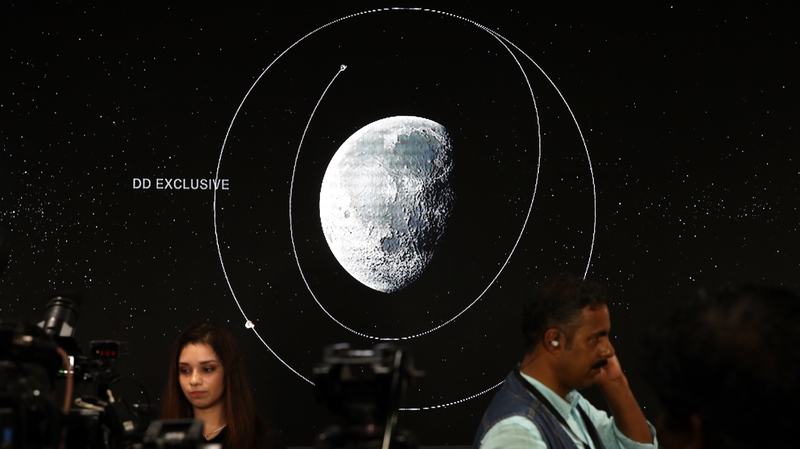 A video of the mission is projected on to a wall at a media centre in India