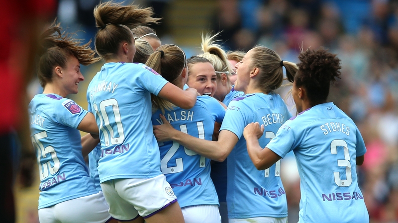 Manchester City players mob Caroline Weir after her spectacular goal at the Etihad