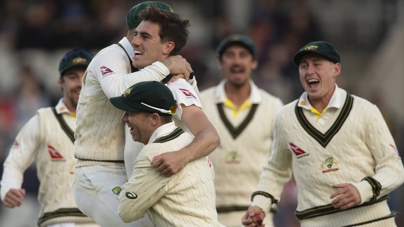Pat Cummins is mobbed after taking the wicket of England captain Joe Root
