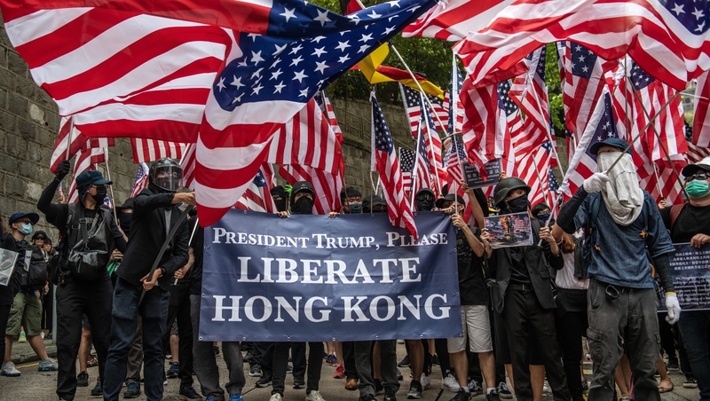 Many protesters waved US flags and held signs calling on President Trump to "liberate" Hong Kong