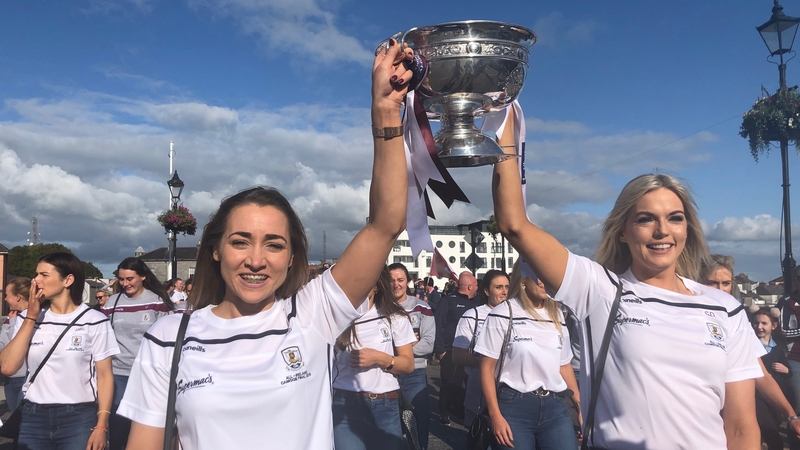 The victorious Galway camogie team carry the O'Duffy Cup across the Shannon into Connacht