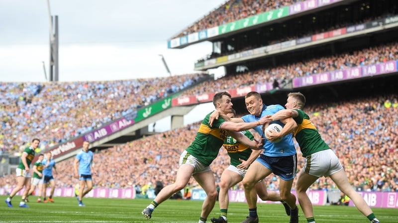 Con O'Callaghan of Dublin in action against Jason Foley of Kerry, right and Tom O'Sullivan of Kerry during the drawn game