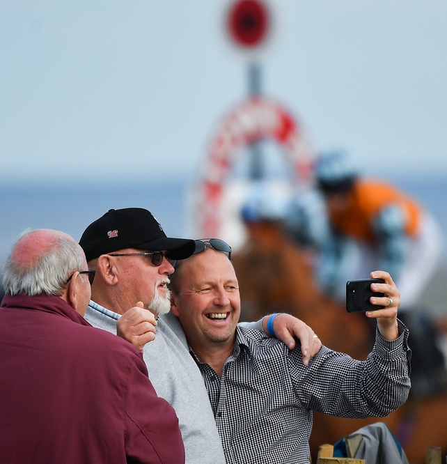 Racegoers snap selfies near the winning post at Laytown