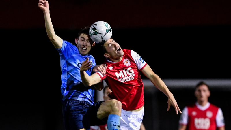 UCD's Dara Keane and Lee Desmond of St Pat's engage in an aerial duel at Richmond Park