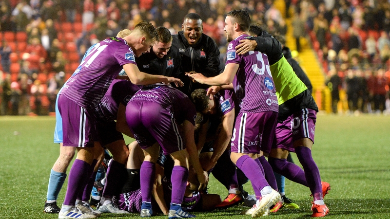 Dundalk players mob Chris Shields after he scored the winning penalty