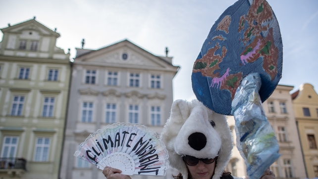 A woman wearing a polar bear costume attends a protest against climate change at the Old Town Square in Prague, Czech Republic